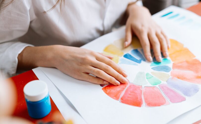 photo where female hands draw a colorful graf