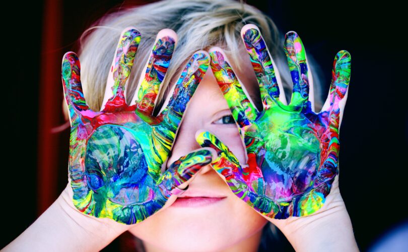 kid with colorful hands